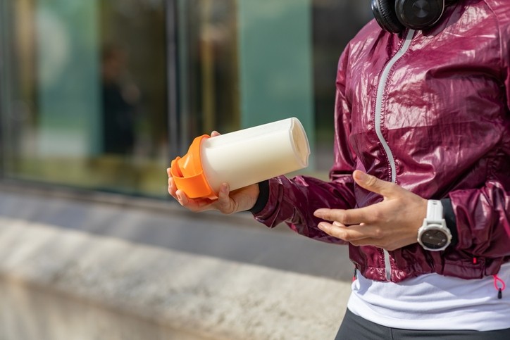 A person preparing a protein shake. © Getty Images